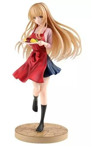 Painted plastic figure of 椎名真昼 (TENITOL) wearing an apron and holding a plate, posed on a round base.