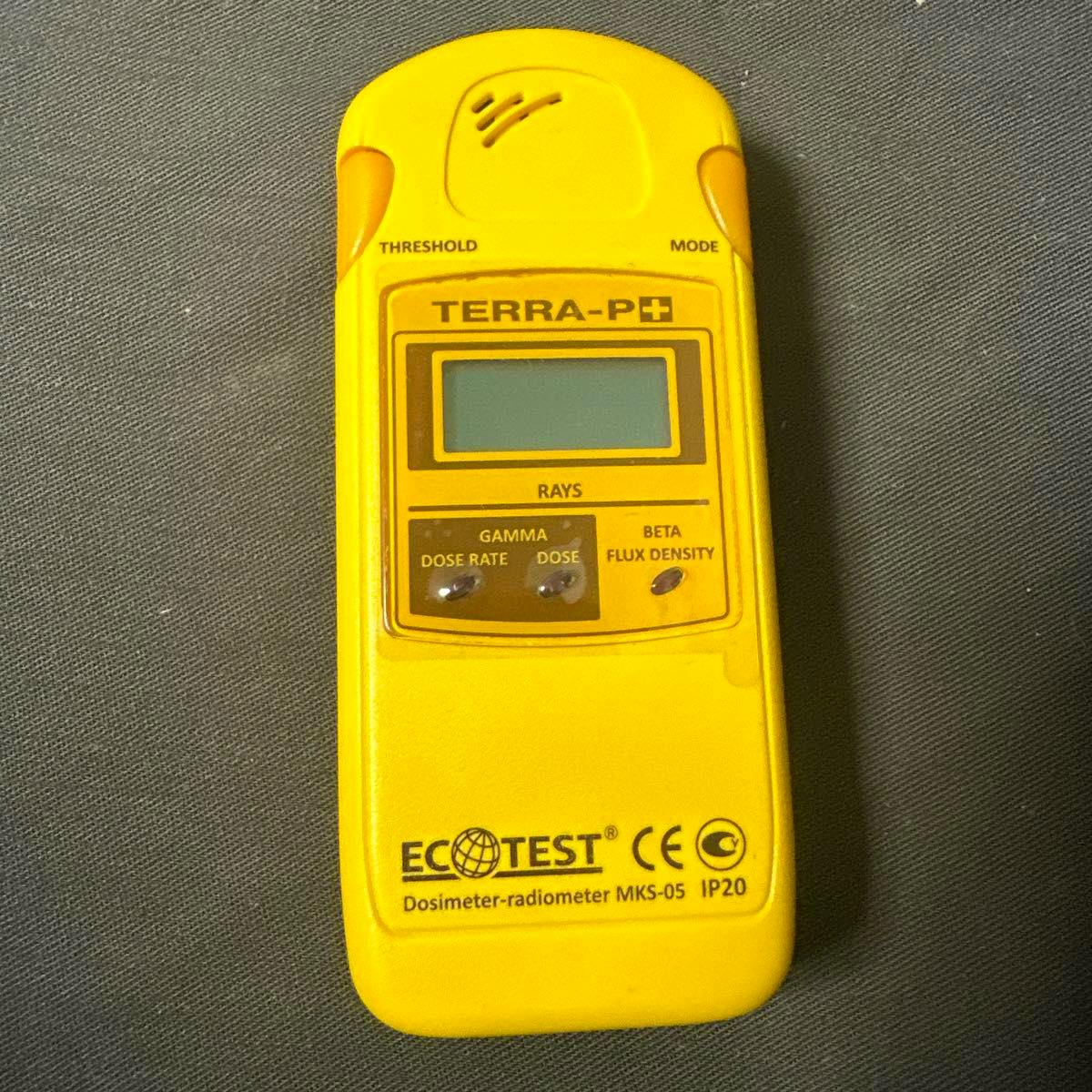 Front view of a yellow TERRA-P+ ECOTEST dosimeter-radiometer MKS-05 showing its LCD, control labels, and ECOTEST branding.
