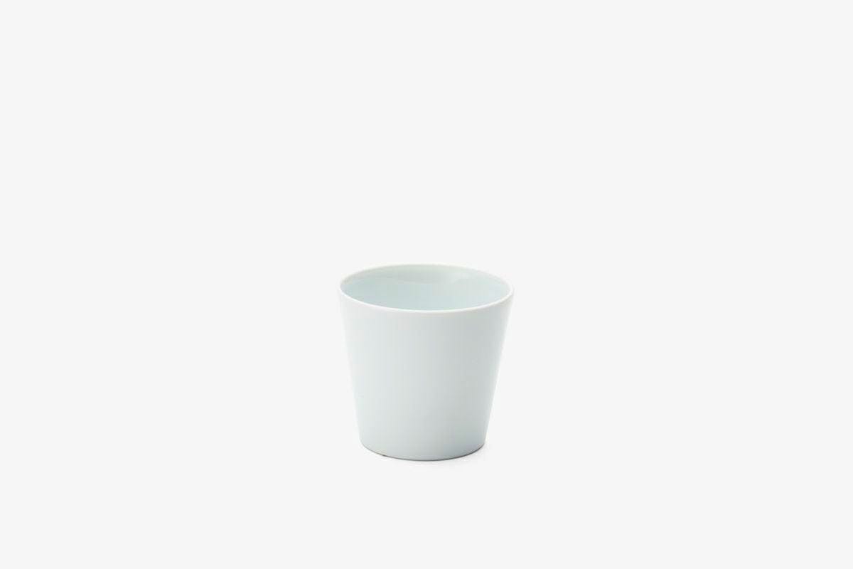 A plain small porcelain cup shown on a white background.