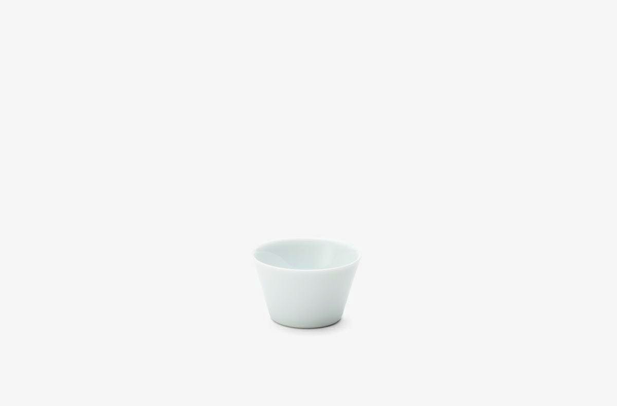 A small white porcelain cup (choko) centered on a plain white background.