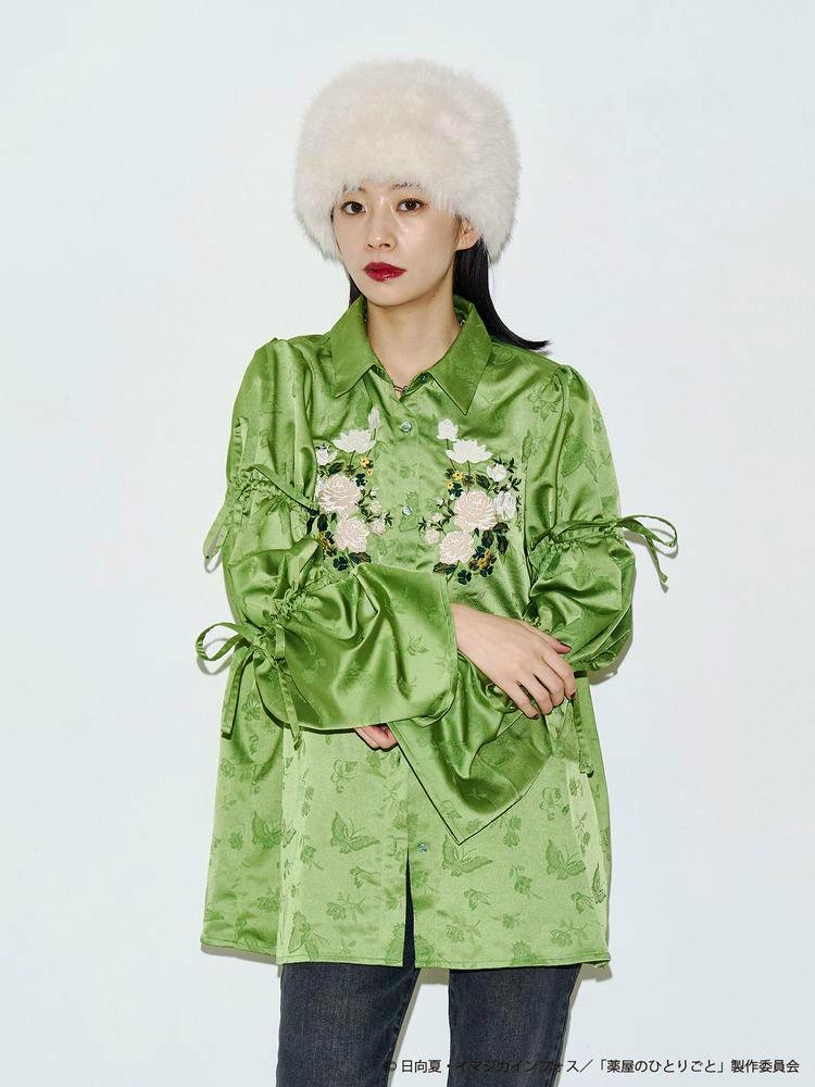 Green JQD tunic shirt with floral embroidery and tied puff sleeves shown on a model.