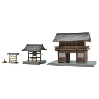 A plastic model set showing temple components (a two-story gate, a bell pavilion, and a small signboard) displayed on bases against a white background.