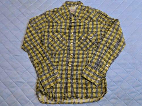 Yellow check long-sleeve men's Western shirt (The Flat Head) laid flat on a quilted surface.
