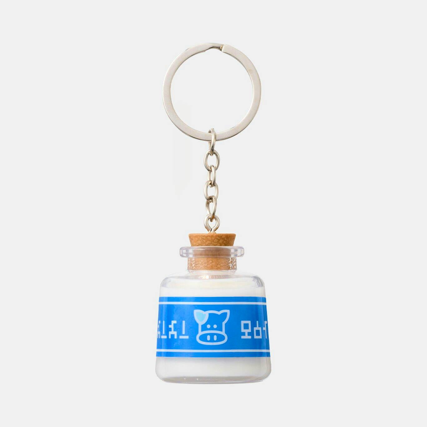 Front view of a Lon Lon Milk keychain showing a small milk-bottle charm with a blue label and metal key ring.