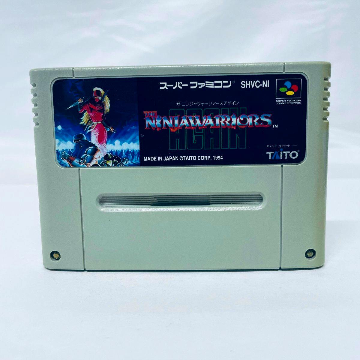 Front view of the Super Famicom cartridge showing the label for The Ninja Warriors Again.