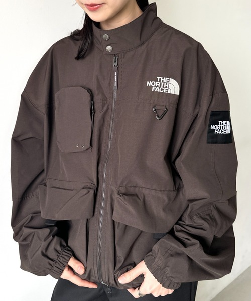 Model wearing a dark brown THE NORTH FACE NEILTON men's jacket with front zipper and chest logo.