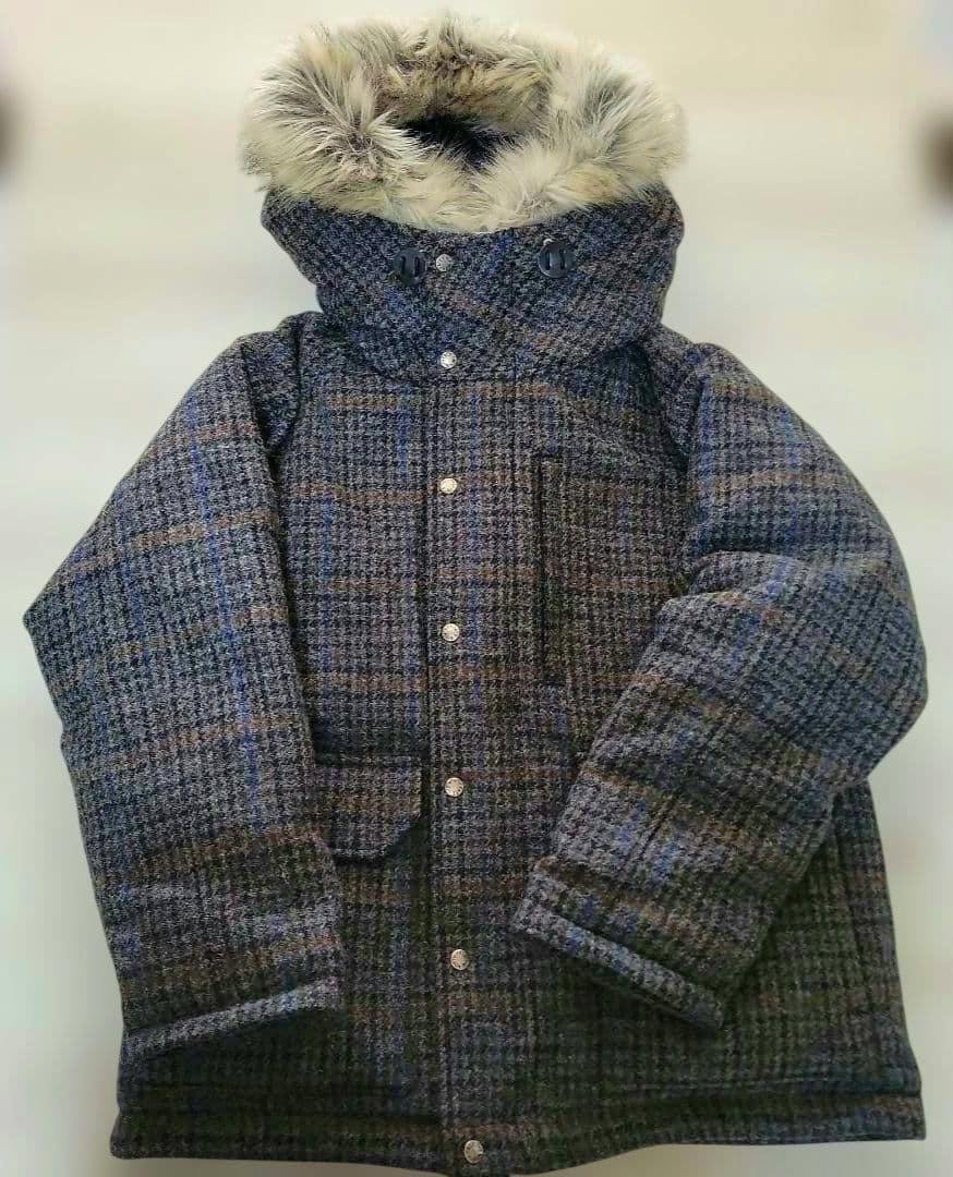 Front view of THE NORTH FACE PURPLE LABEL Harris Tweed men's wool jacket laid flat, showing the fur-trimmed hood and front snap buttons.
