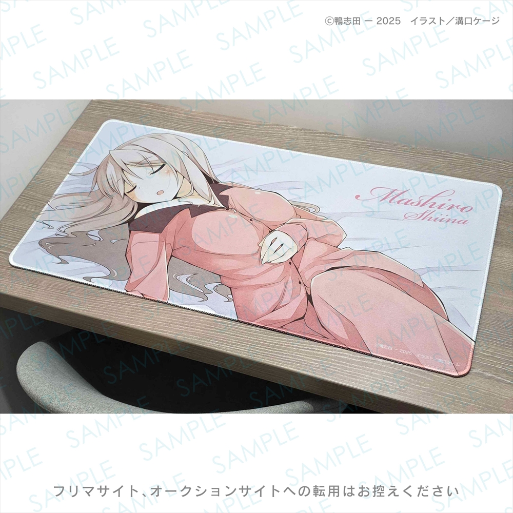 A polyester playmat with a sleeping anime character illustration displayed on a wooden desk.