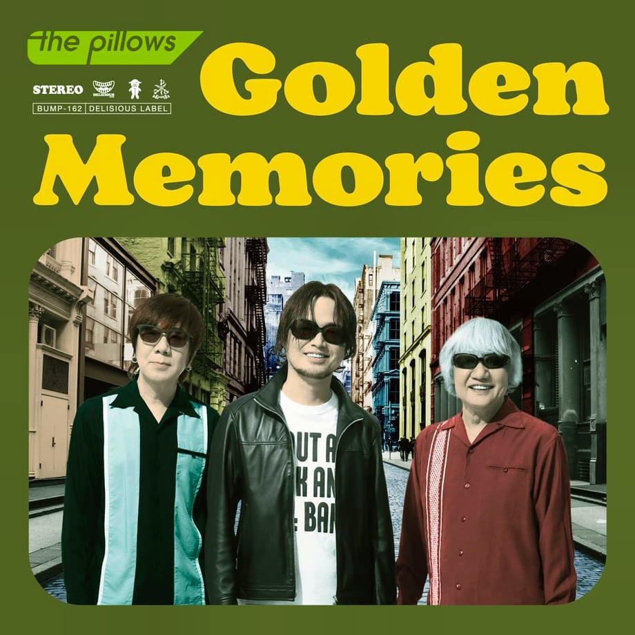 Album cover art for the pillows' EP "Golden Memories" showing the title text above a photo of three band members standing on a city street.