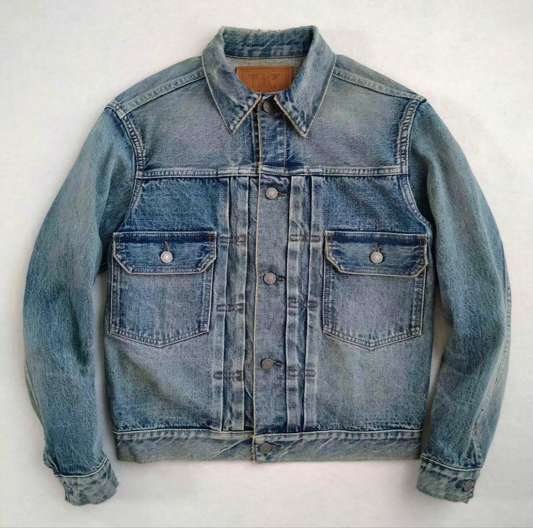 Front view of the men's cotton denim jacket showing collar, button-front placket, and two flap chest pockets.