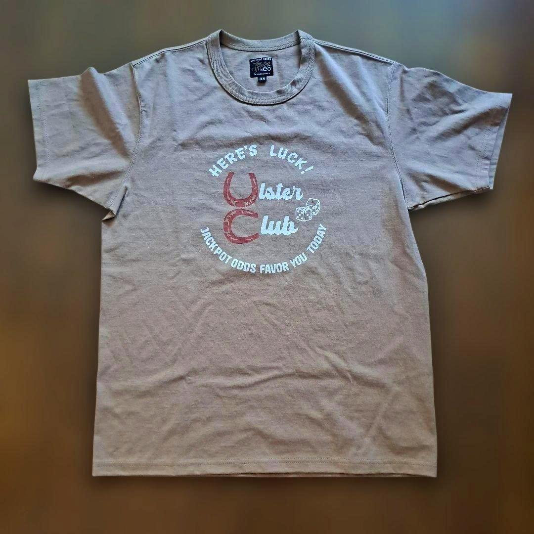 Beige cotton T-shirt laid flat showing the front printed graphic and short sleeves.