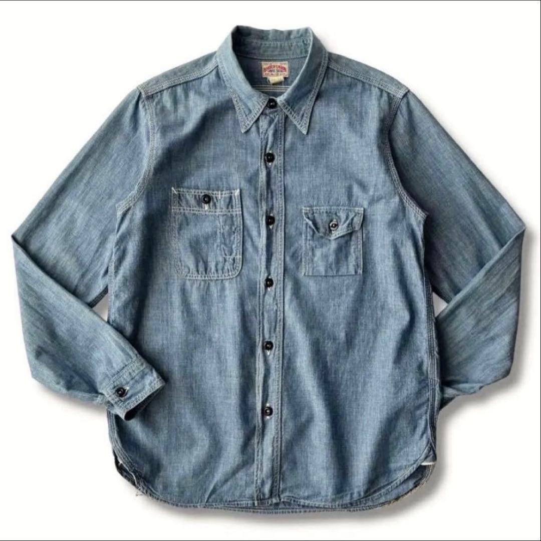 Flat-lay photo of a men's cotton chambray long-sleeve shirt with two chest pockets and a button-front.
