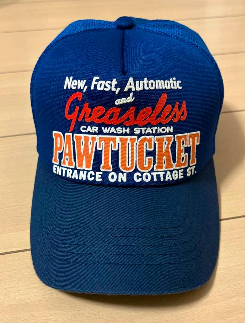 Blue mesh baseball cap shown front-on with embroidered orange and white "PAWTUCKET" text on the front.