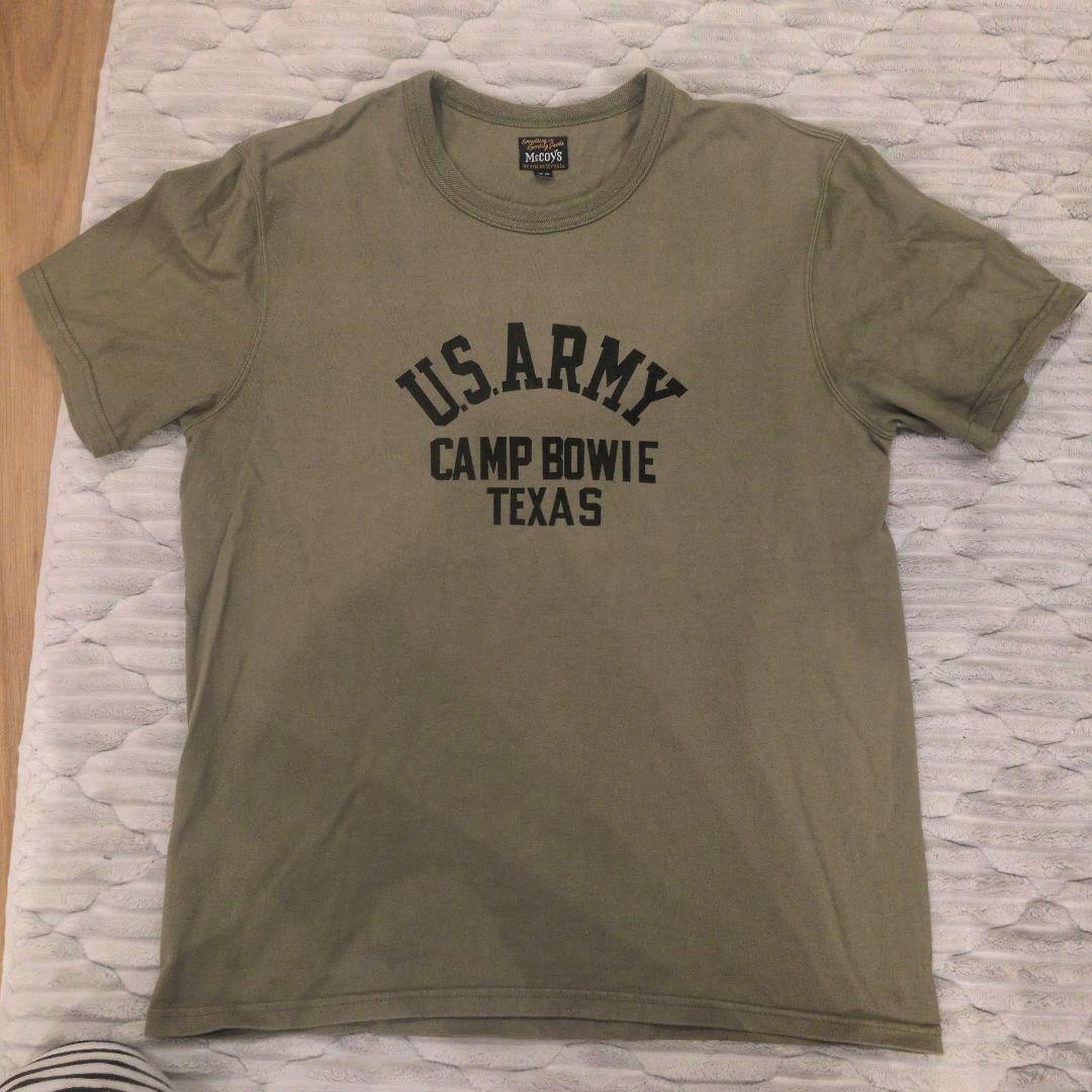 Olive/khaki T-shirt laid flat showing the front print reading "U.S. ARMY CAMP BOWIE TEXAS".