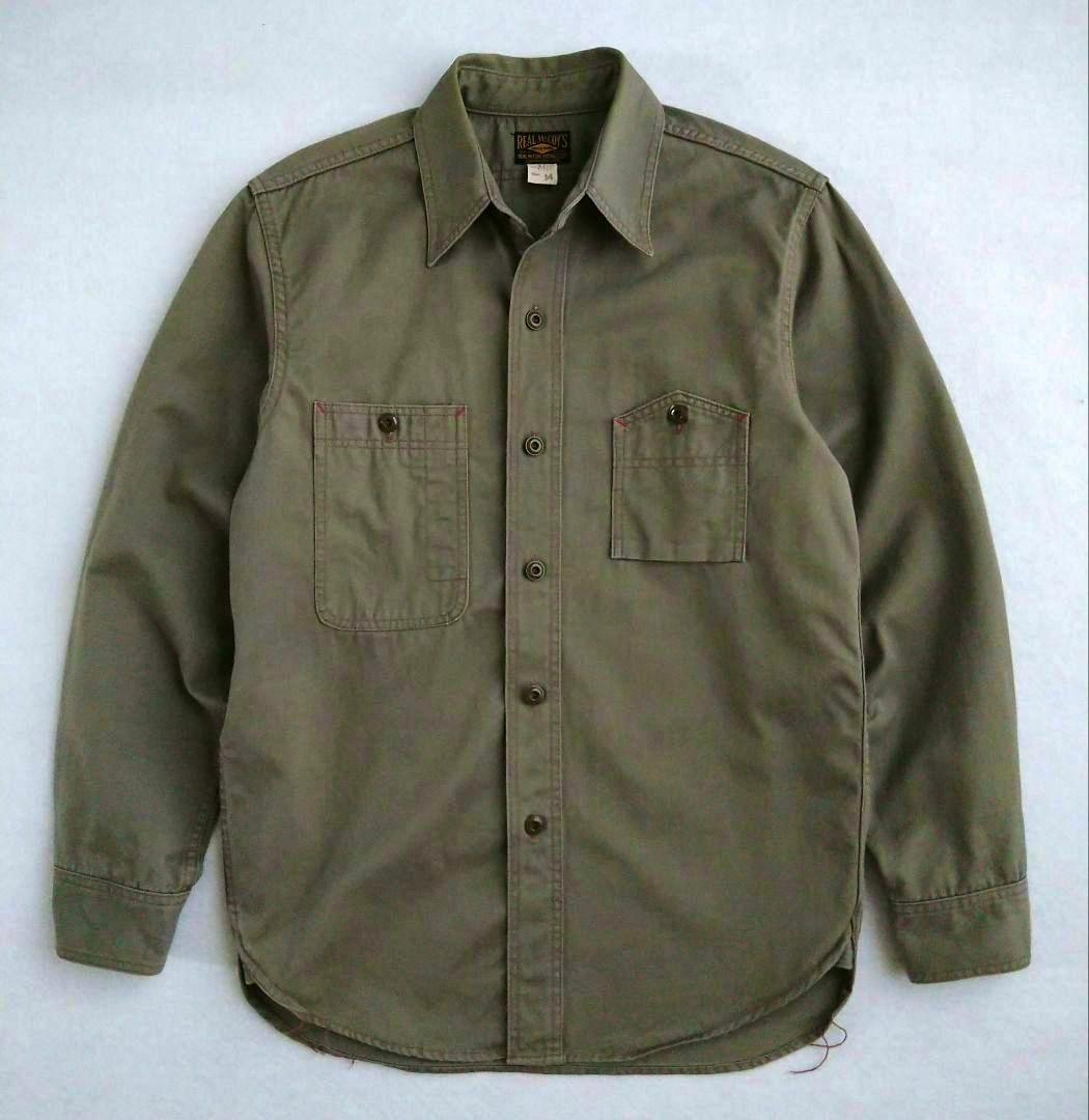 Front view of an olive/khaki men's work shirt laid flat showing button front and two chest pockets.