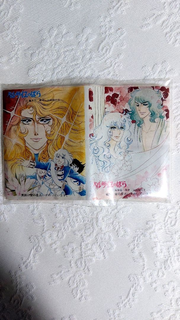 Two pocket tissue packs featuring artwork from "The Rose of Versailles" photographed on a white textured surface.