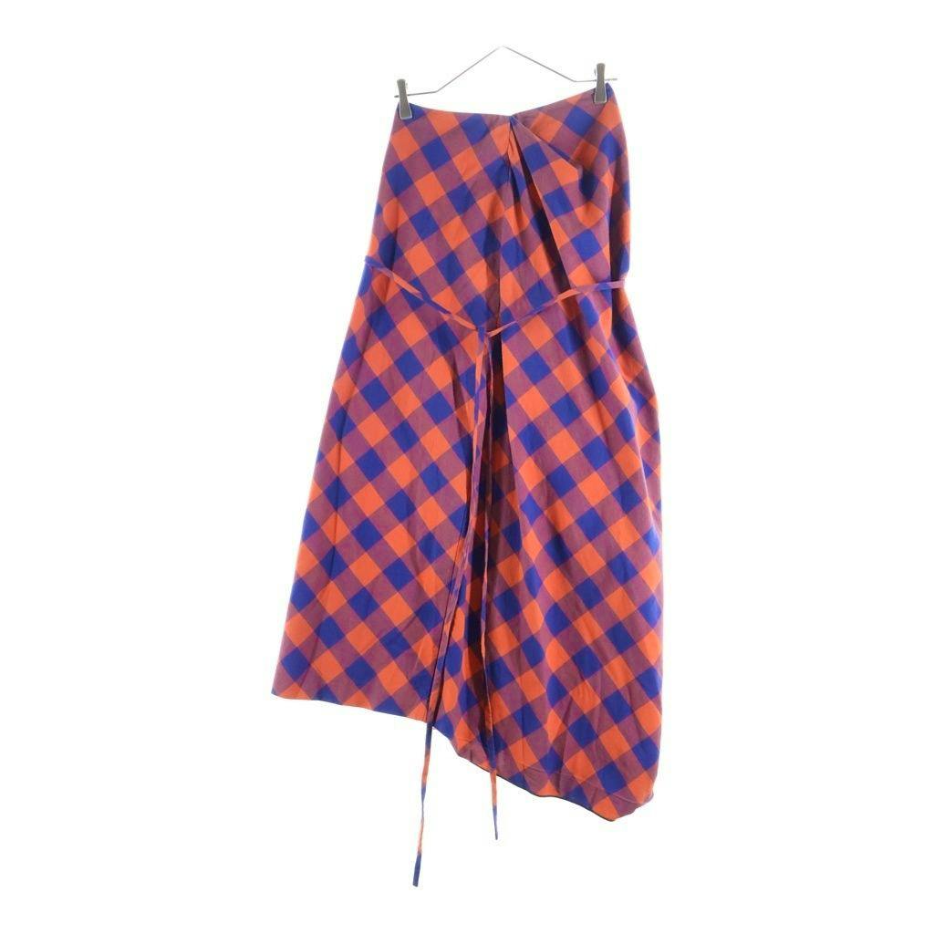 Asymmetric long women's skirt in red check pattern hanging on a hanger against a white background.