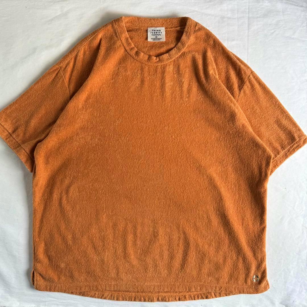 Orange THING FABRICS 2mm pile cotton T-shirt (XL) laid flat showing the front and neckline.