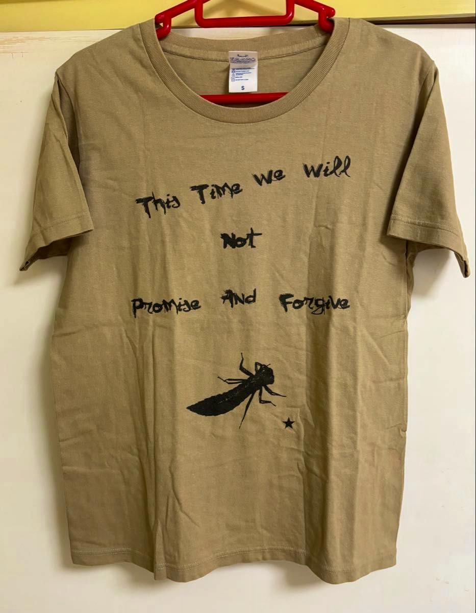 Beige men's band T-shirt (size S) on a hanger, front view showing black printed text and an insect graphic.