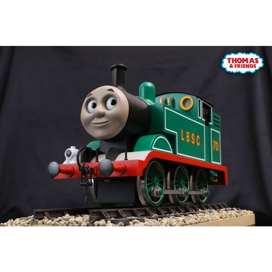 Front-side photo of the green Thomas prop replica model on track showing the locomotive's face, wheels, and side detailing.