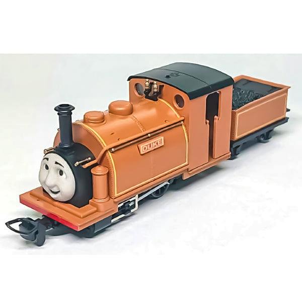 Angled photo of the orange Duke-type Thomas the Tank Engine plastic figure with its coal tender.