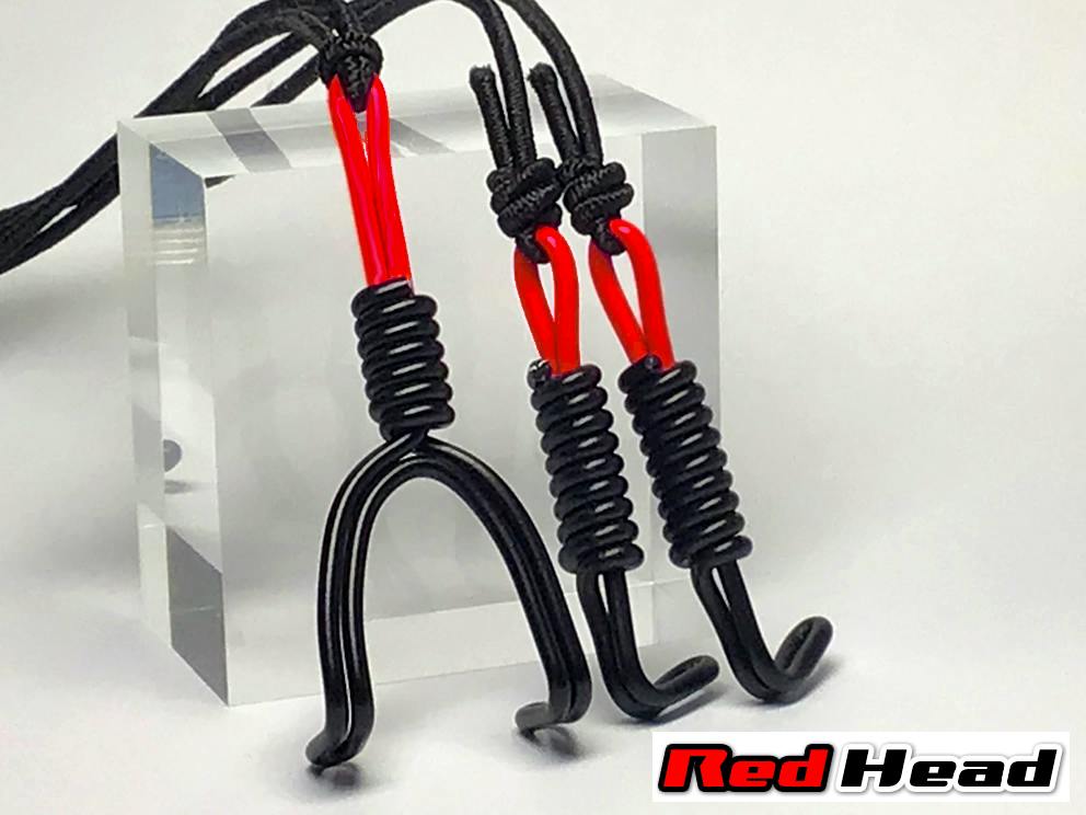A three-direction plastic nose hook set in red and black displayed on a clear acrylic block with a "Red Head" logo.