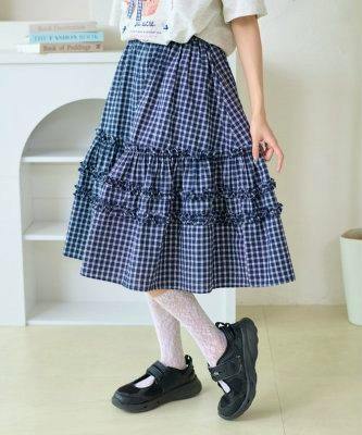 Model wearing a blue checked tiered frill midi skirt shown from waist to shoes.