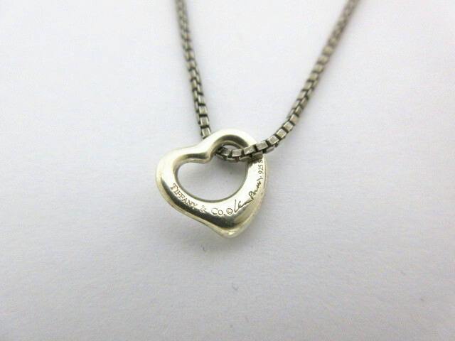 Close-up of the Tiffany & Co. mini open-heart sterling silver necklace pendant on a box chain.