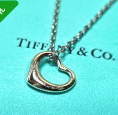Silver TIFFANY Open Heart SV925 necklace pendant and chain displayed on a Tiffany & Co. blue background.