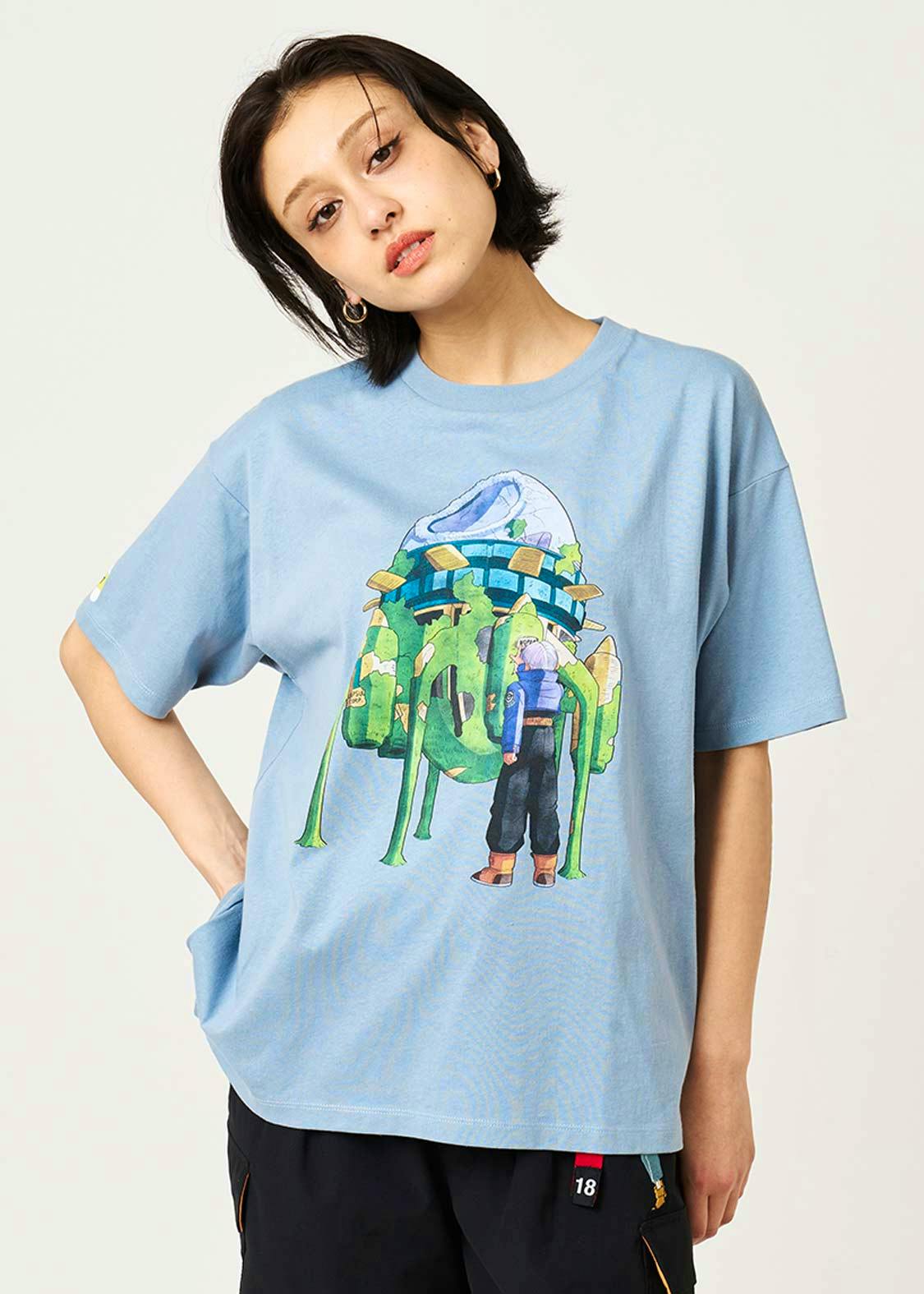 Front view of a model wearing the light blue big-silhouette T-shirt with a colorful time-machine illustration on the front.