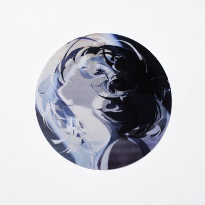 Postcard front showing a circular lenticular illustration of a stylized monochrome female face on a white background.