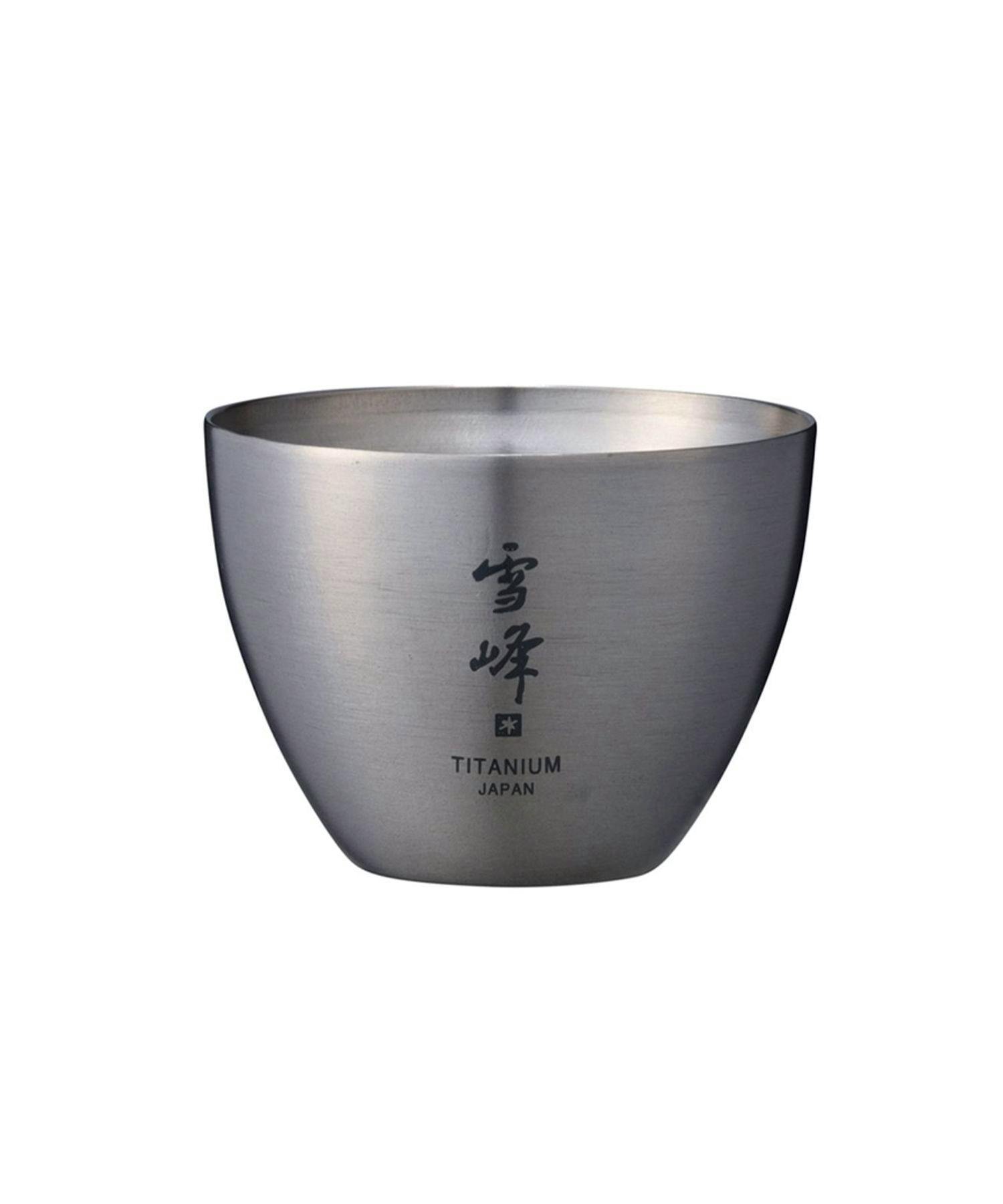 Close-up of a titanium cup showing its brushed metal surface, Japanese characters, and the text "TITANIUM JAPAN".