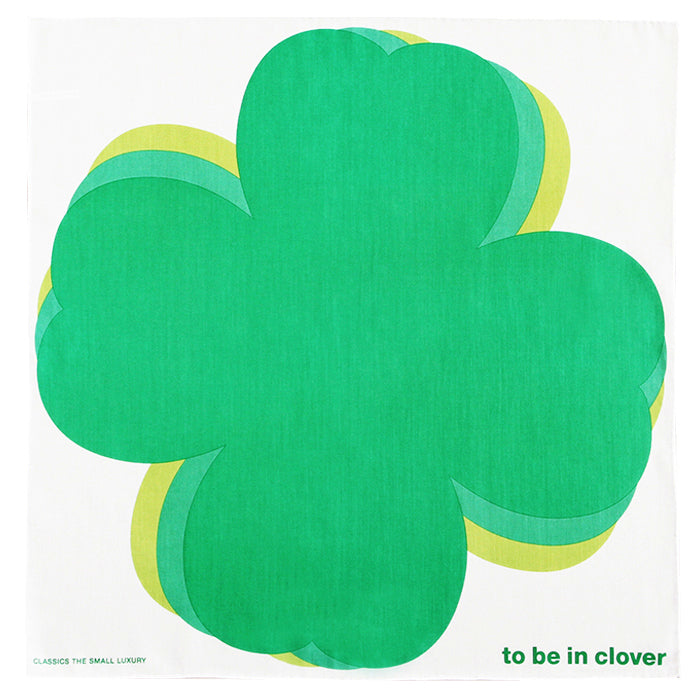 White cotton handkerchief with a large green stylized four-leaf clover and the text "to be in clover" in the lower right.