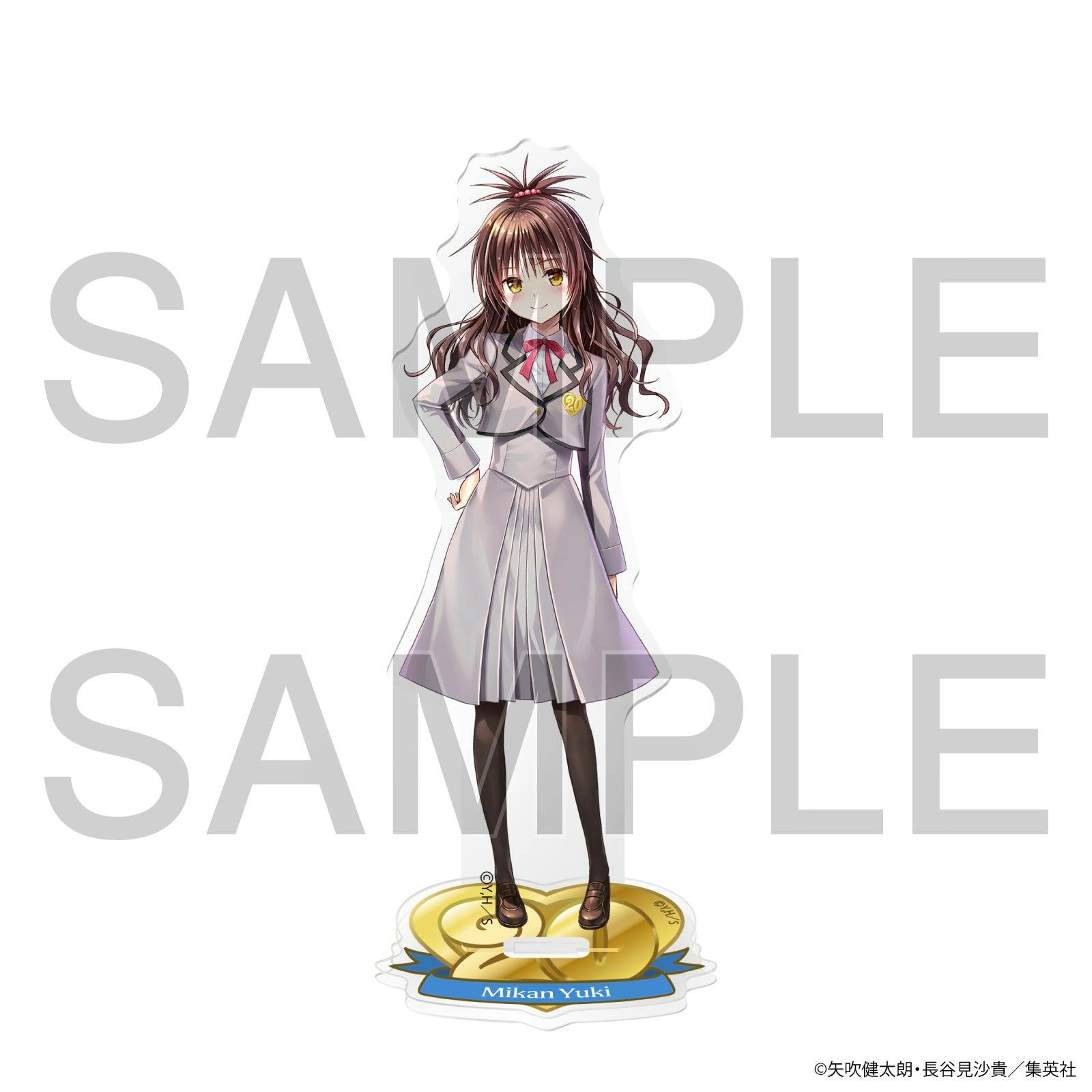 Front view of the acrylic stand showing Mikan Yuki in her school uniform standing on a gold heart-shaped base.