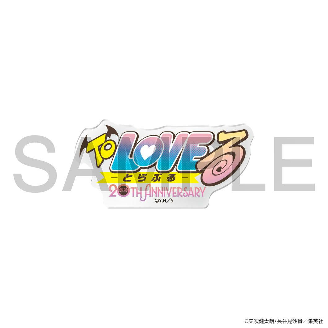 An acrylic block showing the To LOVE logo design with "20th Anniversary" text on a white background.