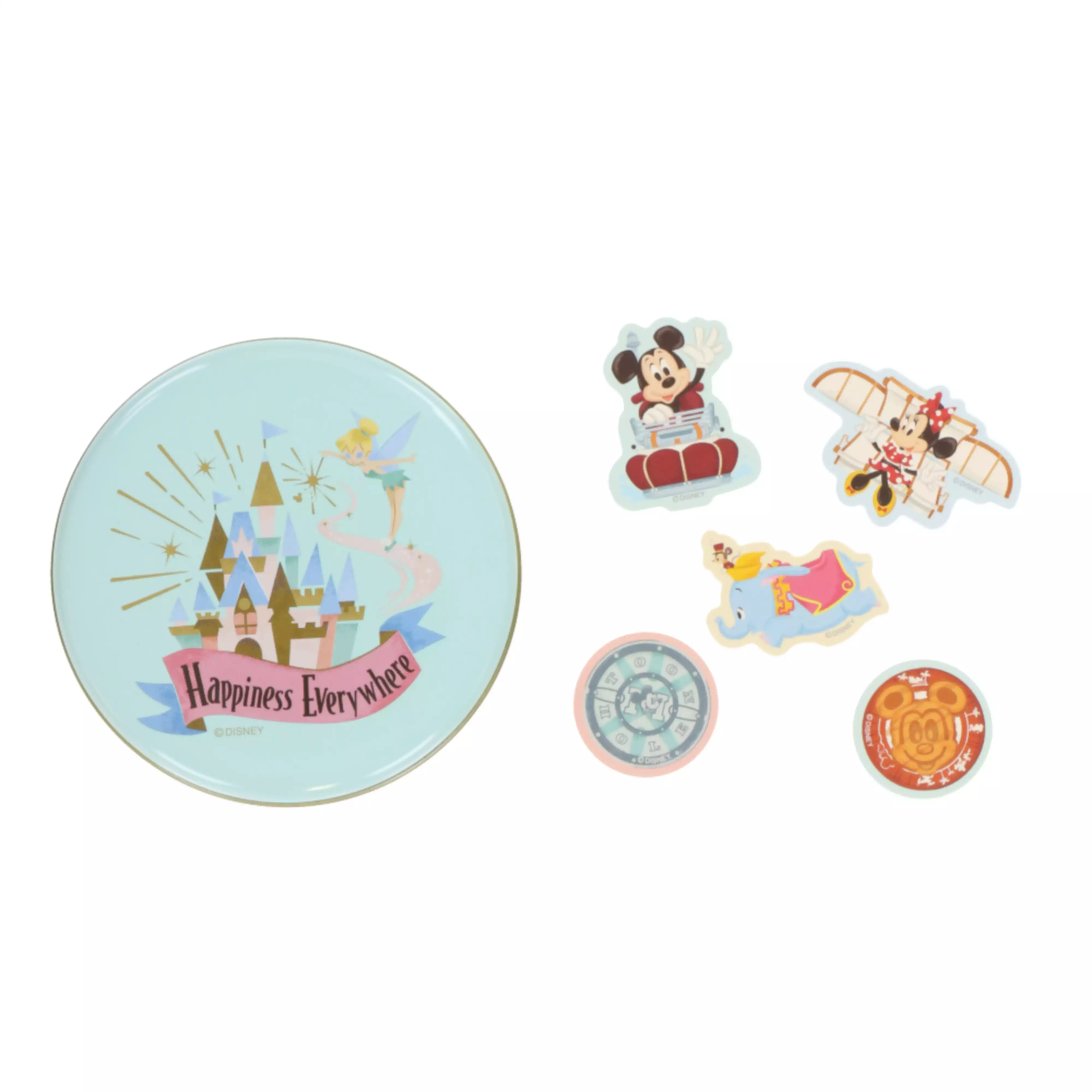 A round tin with a castle illustration and the text "Happiness Everywhere" alongside several Tokyo Disney Resort character stickers.