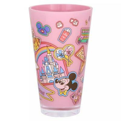 Pink plastic Tokyo Disneyland tumbler decorated with Disney-themed illustrations including Mickey Mouse and a castle.