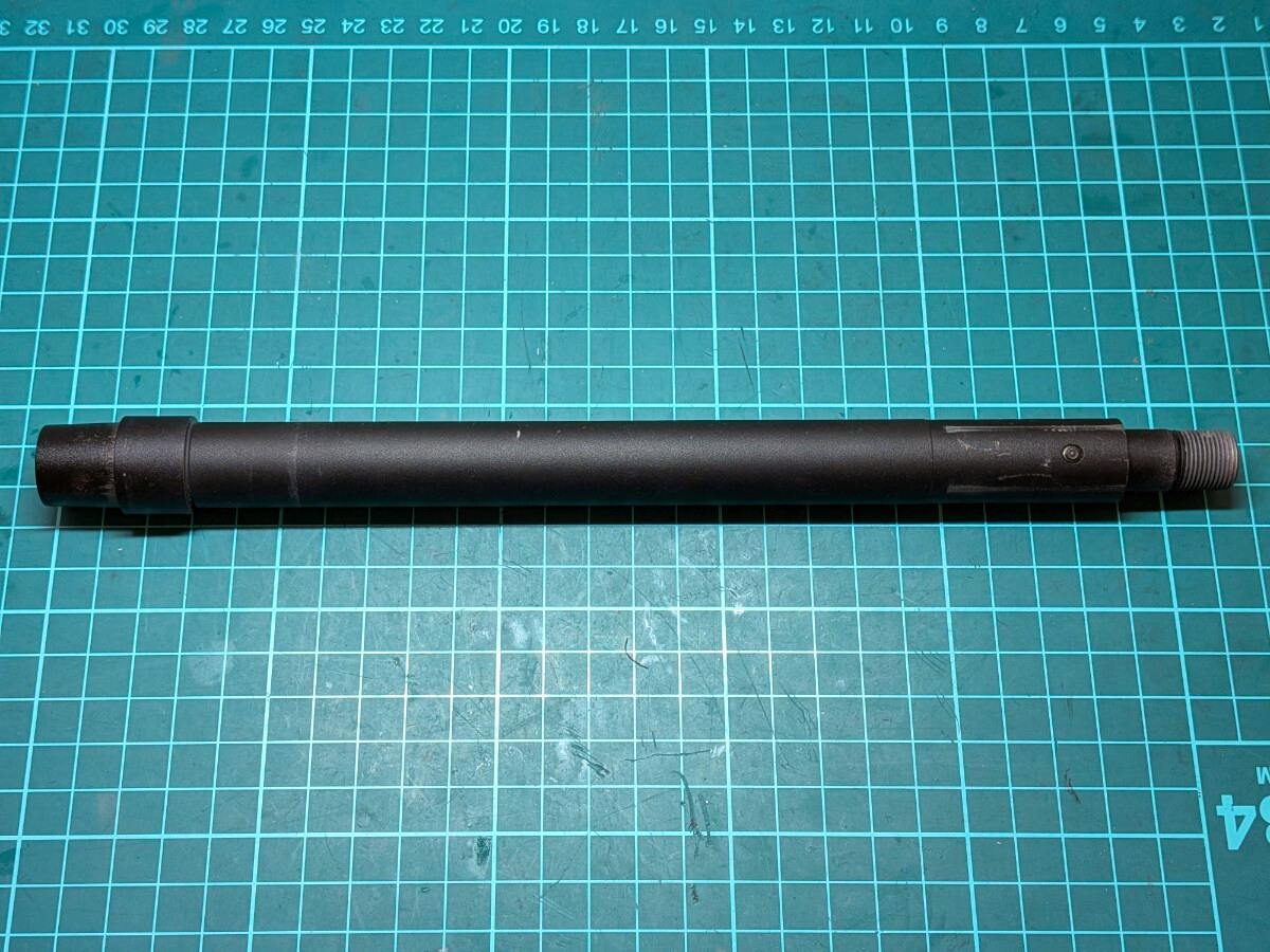 Marui-made outer barrel for a next-generation HK416D electric airsoft gun lying on a green cutting mat.