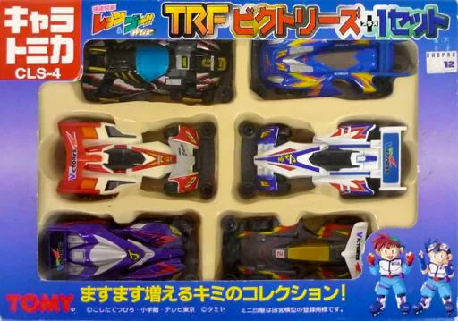 Front view photo of the Tomica TRF Victories+1 six-car set showing six miniature metal toy racing cars in a molded tray inside the product box.