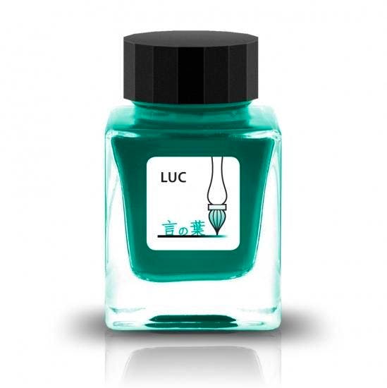 Square glass bottle of Tono&Lims ガラス工房LUC 言の葉 fountain pen ink in teal with a black cap and label showing "LUC" and a brush icon.