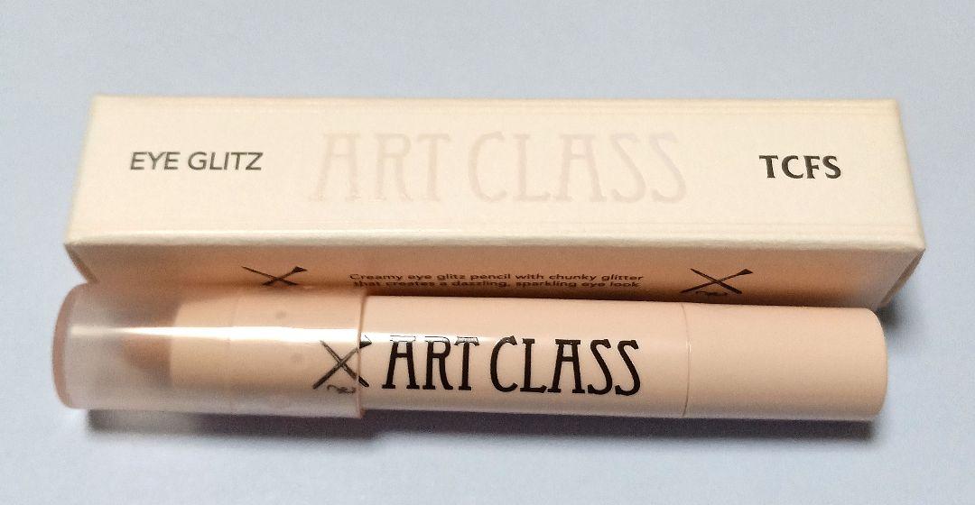 Too cool for school Art Class Eye Glitz #1 Bubbly Angel eye shadow tube shown next to its outer box.