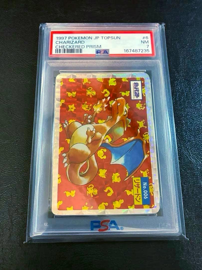 PSA-graded slab containing a Checkered Prism Charizard trading card with the PSA label visible.