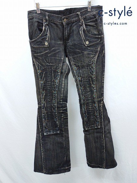 Front view of black denim flare pants with detailed paneling hung on clips against a white background.
