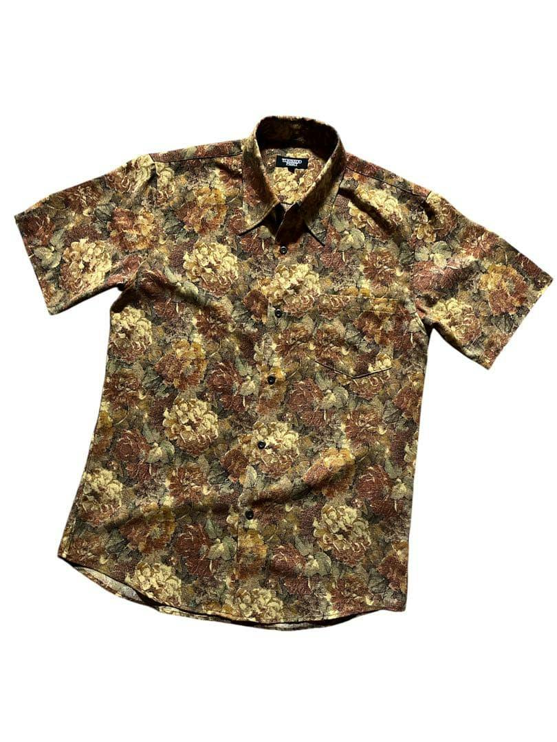 Front view of a men's short-sleeve floral Tornado Mart shirt laid flat showing the full front.
