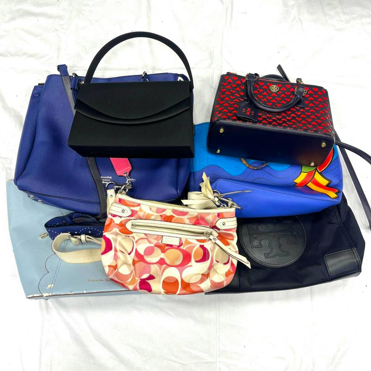 Seven assorted handbags and pouches arranged together on a white background.