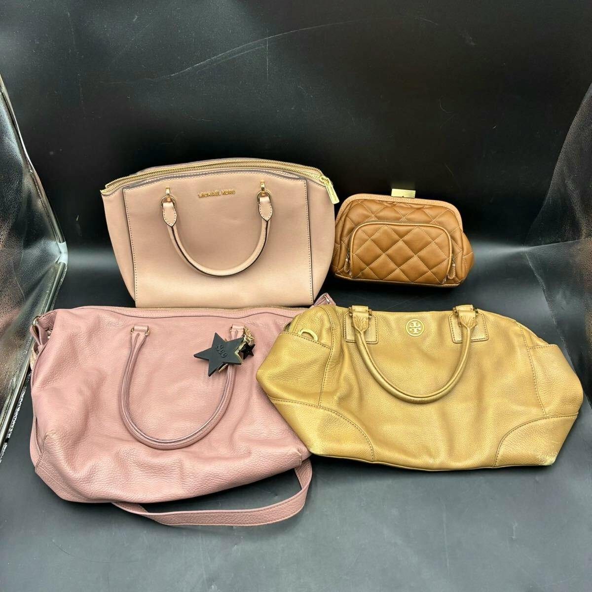 Four leather bags (TORY BURCH, MICHAEL KORS and others) displayed on a black background.