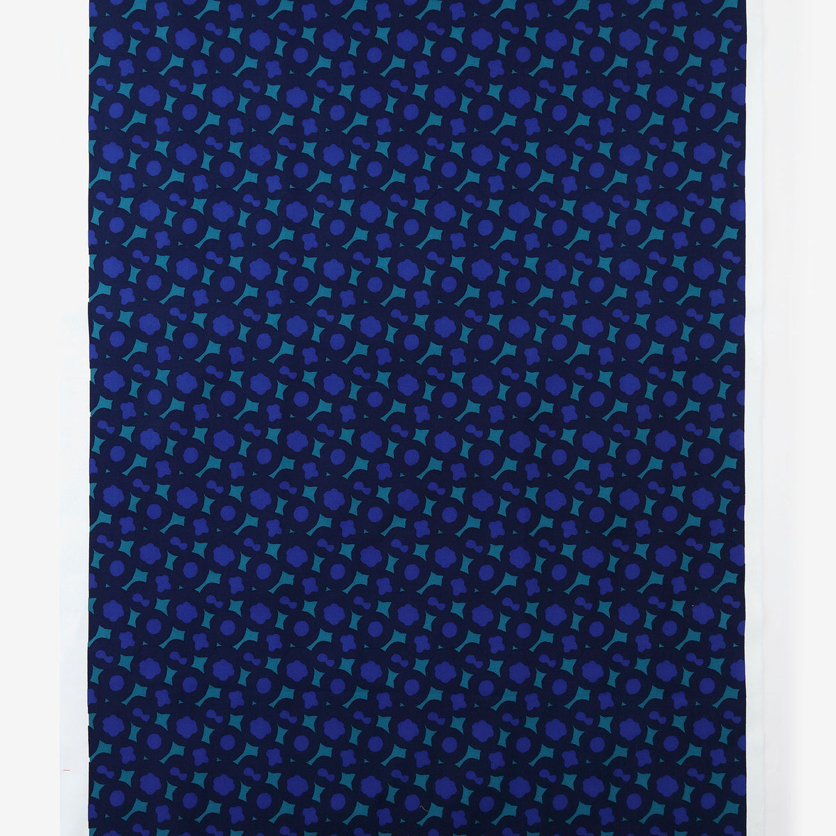 Navy-blue cotton fabric panel showing an all-over repeating teal and purple geometric pattern.