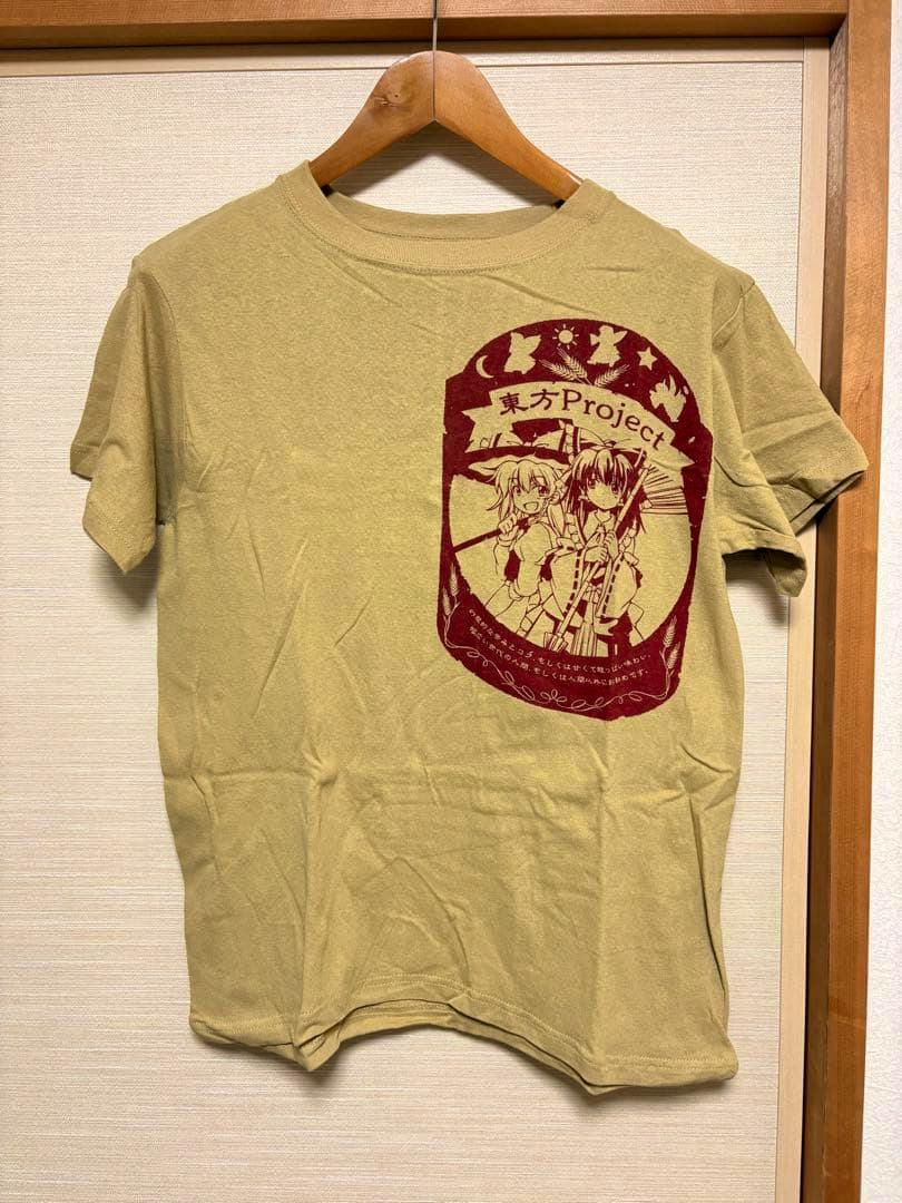 Front view of a khaki T-shirt on a wooden hanger featuring a red "東方Project" graphic print.