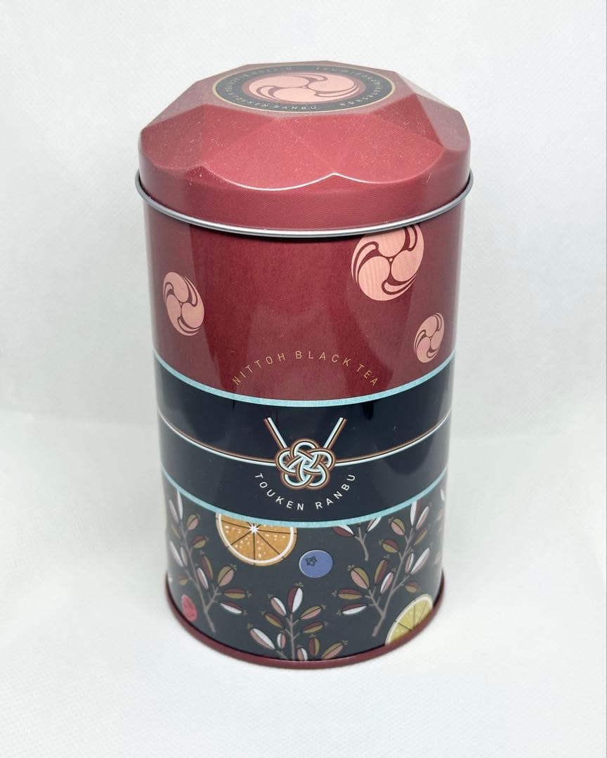 Decorative tin canister with a red lid and patterned bands featuring Touken Ranbu motifs.