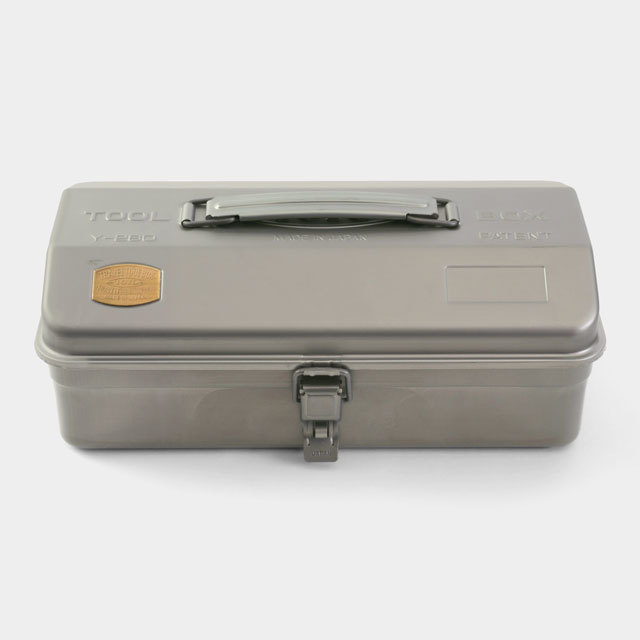 Closed metal trunk-style toolbox with a top handle and front latch on a white background.
